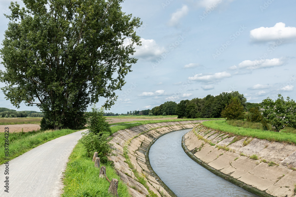 The meandering River Senne with the green banks and a bicycle trail