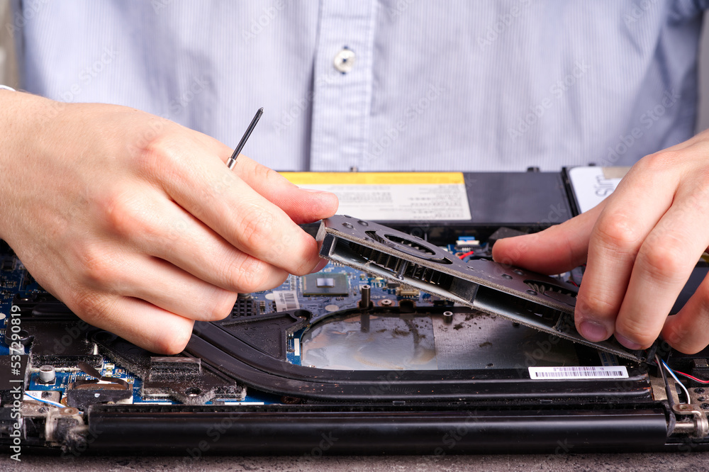 Hands fixing motherboard of pc or laptop notebook close up in service. Laptop repair service. PC hardware upgrade and maintenance. Engineer fixing broken notebook. Hands fixing motherboard of pc or laptop notebook close up in service. Laptop repair service. PC hardware upgrade and maintenance. Engineer fixing broken notebook.