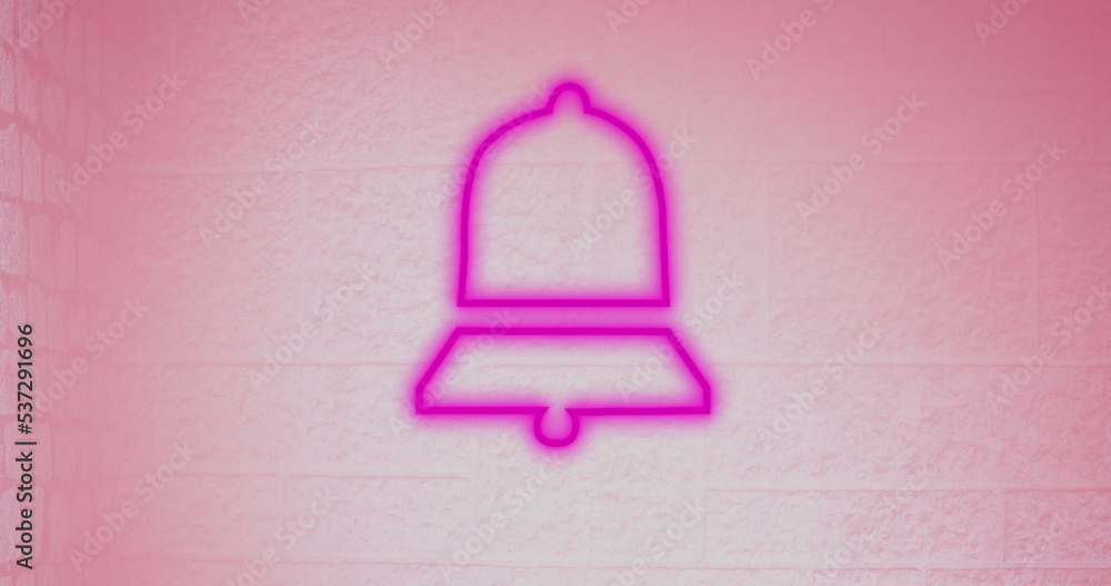 Composite of illuminated digital notification bell icon against pink wall, copy space Composite of illuminated digital notification bell icon against pink wall, copy space