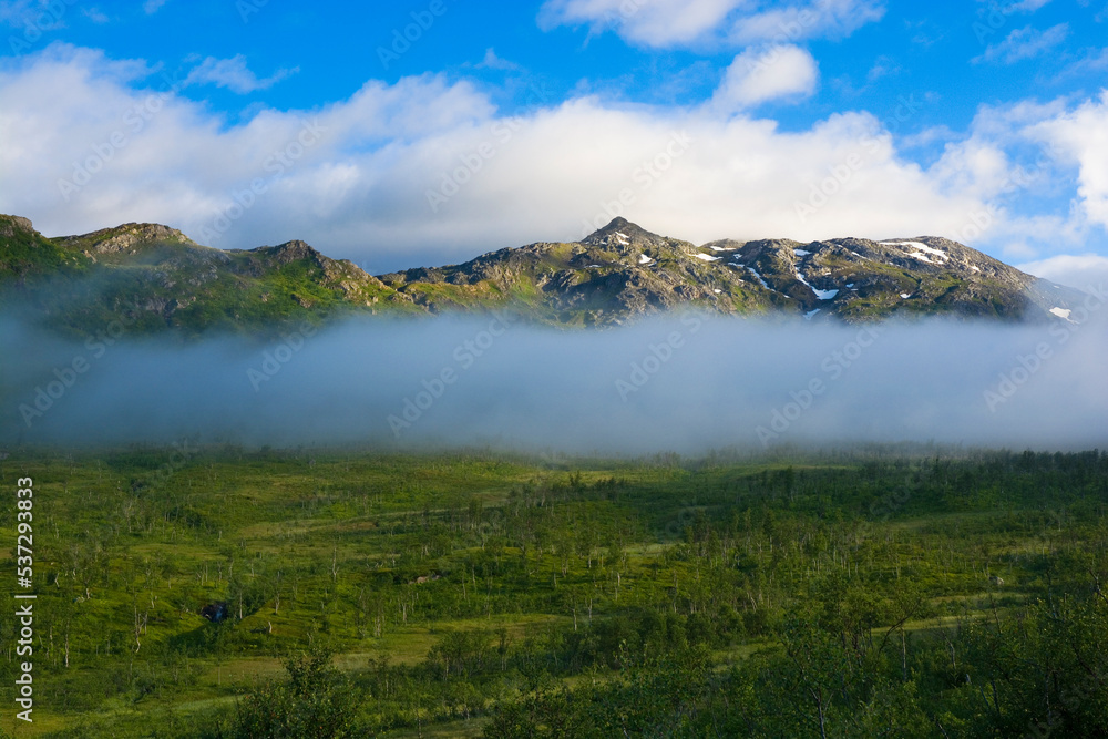 View of foggy mountains on Kvaloya island, Norway