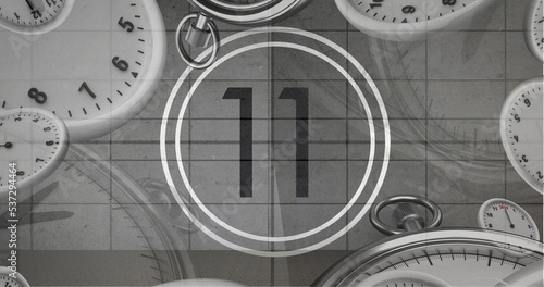 Image of number eleven in vintage black and white film projector countdown with clocks and watches photo