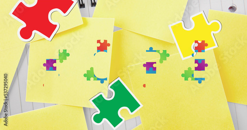 Composite of colorful jigsaw pieces with yellow blank sticky notes on table, copy space