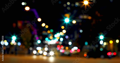 Full frame shot of defocused road with multicolored illuminated street lights in city at night