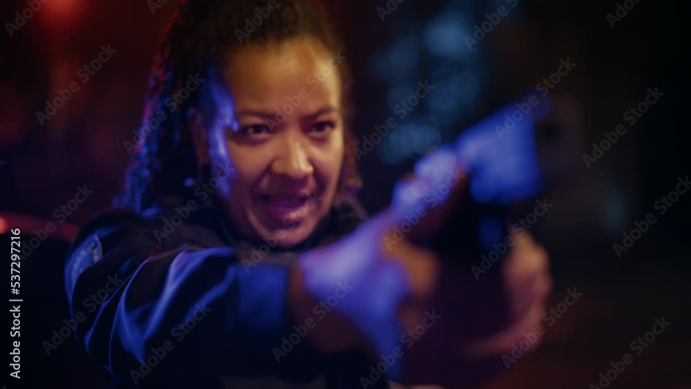 Portrait of Black Female Police Officer Aiming Gun at Criminal, Orders to Drop the Weapon and Stop Resisting Arrest. Officer of the Law Fights Crime, Prevents Murder. Focusing Cinematic Slow Motion Portrait of Black Female Police Officer Aiming Gun at Criminal, Orders to Drop the Weapon and Stop Resisting Arrest. Officer of the Law Fights Crime, Prevents Murder. Focusing Cinematic Slow Motion