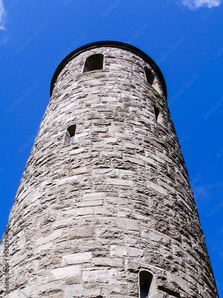 Irish round tower against a blue sky