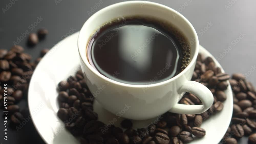 hot coffee cup on table with coffee beans hot coffee cup on table with coffee beans