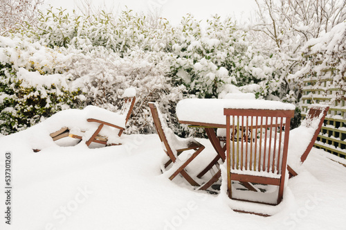 Snow covers wooden patio furniture, Northern Ireland. photo