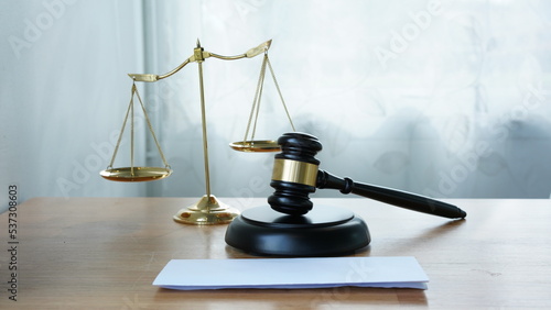 Lawyer or judge's hammer in the court. Auction's hammer is on woo table. Law subject. Judgement subject to judge people.