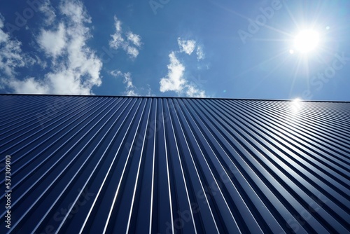 Low angle shot of a metal roof of a building on a sunny day