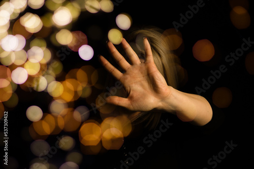 Girl hand and Christmas decoration with bokeh lights.