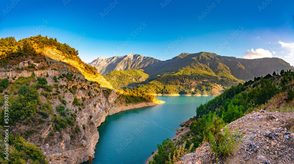 Beautiful picturesque landscape of the nature of a mountainous region with a gorge in which a lake is spread.