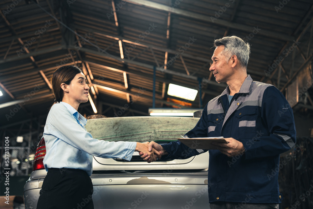 mechanic technician making handshake deal with business customer at