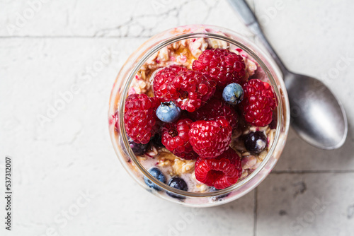 Obraz na plátne Overnight oatmeal with berry, peanut butter and maple syrup in jar