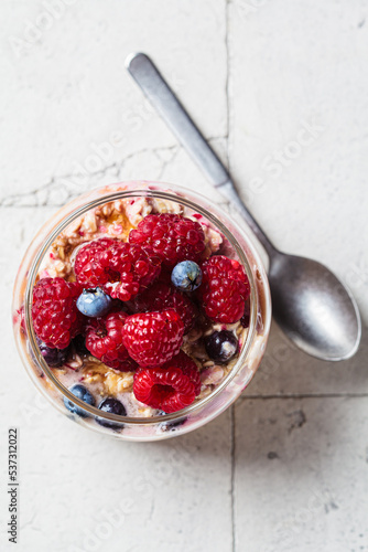 Obraz na plátne Overnight oatmeal with berry, peanut butter and maple syrup in jar