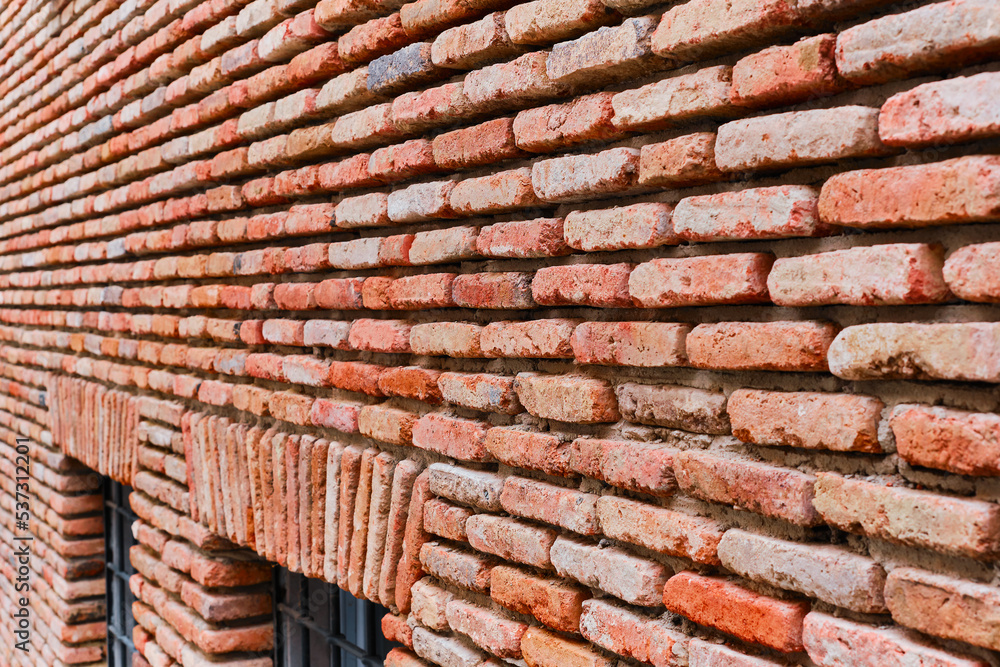 Brick facades of old houses, renovation of houses in old cities. The idea of a background or screensaver from red old brick, wallpaper design for loft apartments. Brick facades of old houses, renovation of houses in old cities. The idea of a background or screensaver from red old brick, wallpaper design for loft apartments.