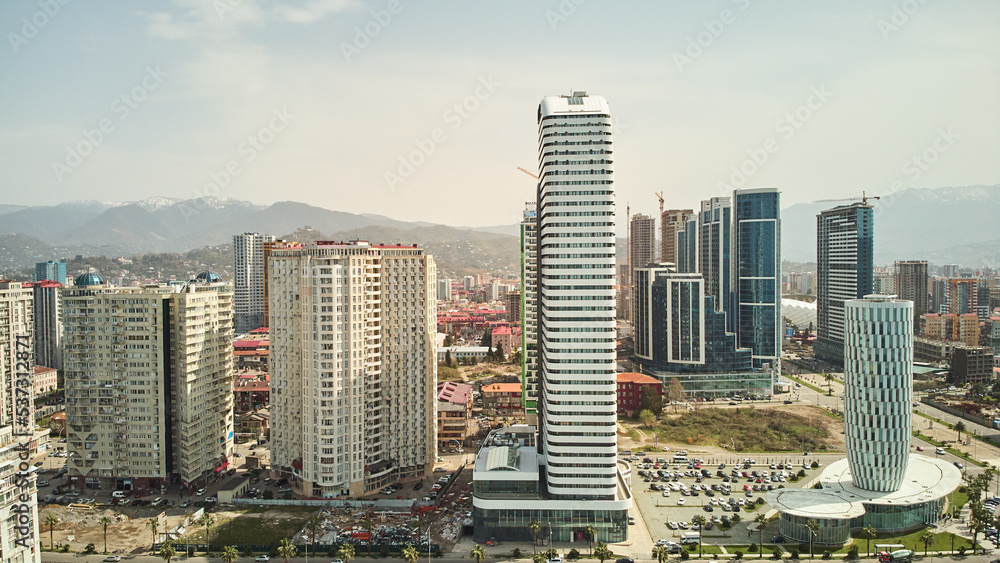 Fototapeta premium Aerial view of the modern architecture of Batumi with mountains background. High quality photo