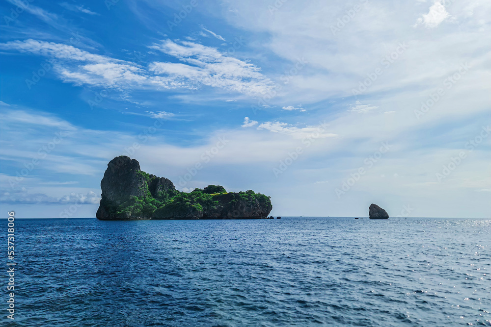 Beautiful island rock mountain landmark and peace sea ocean water in Thailand with cloud blue sky background landscape