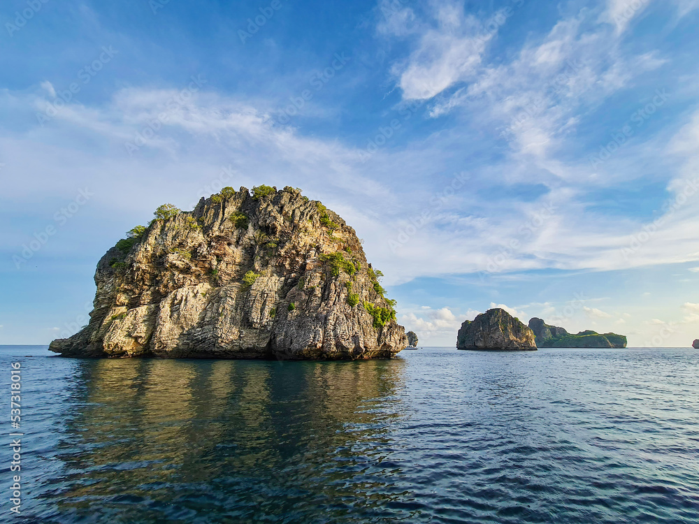 Island rock stone dive site travel destination at south of Thailand andaman ocean sea with cloud blue sky background landscape