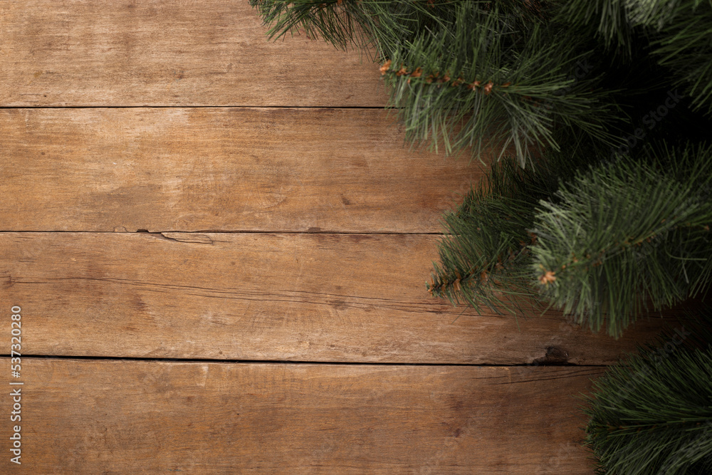Wooden background with branches of a Christmas tree. Concept for Christmas and New Year. Banner. Flat lay, top view Wooden background with branches of a Christmas tree. Concept for Christmas and New Year. Banner. Flat lay, top view