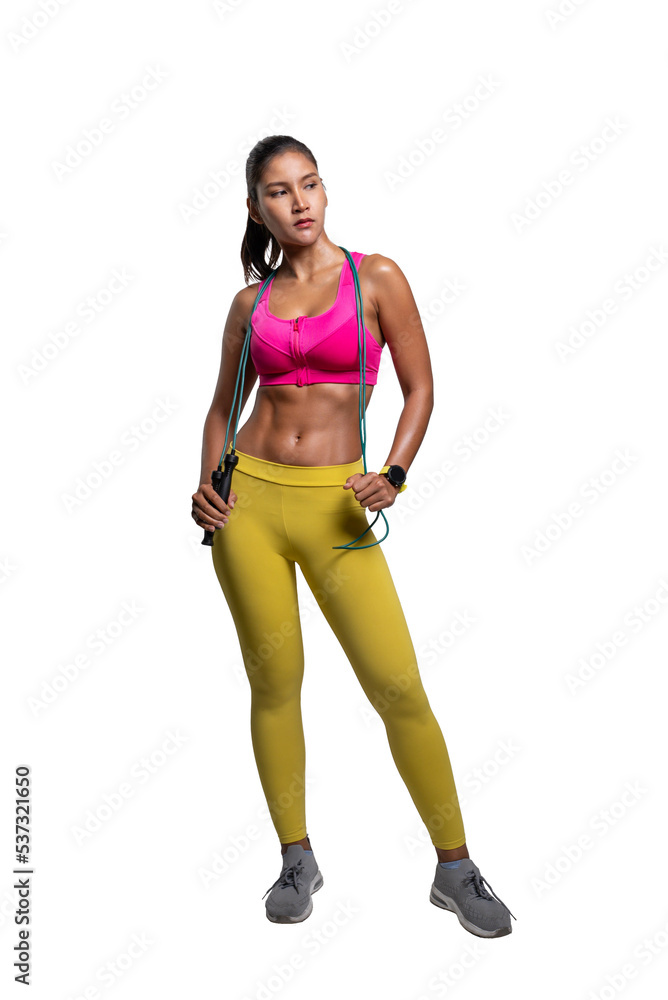 Full body length shot of smiling young sporty Asian woman fitness model in pink sportswear standing with a skipping rope. isolated on white background. Fitness and healthy lifestyle concept. Full body length shot of smiling young sporty Asian woman fitness model in pink sportswear standing with a skipping rope. isolated on white background. Fitness and healthy lifestyle concept.