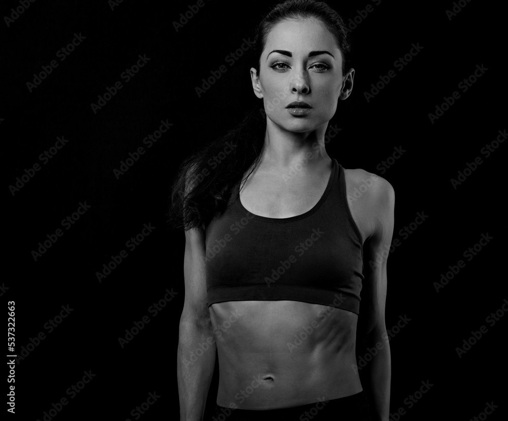 Happy pretty fit healthy fitness woman in sporty top clothing bra looking sexy on black background with empty copy space. Healthy portrait Happy pretty fit healthy fitness woman in sporty top clothing bra looking sexy on black background with empty copy space. Healthy portrait