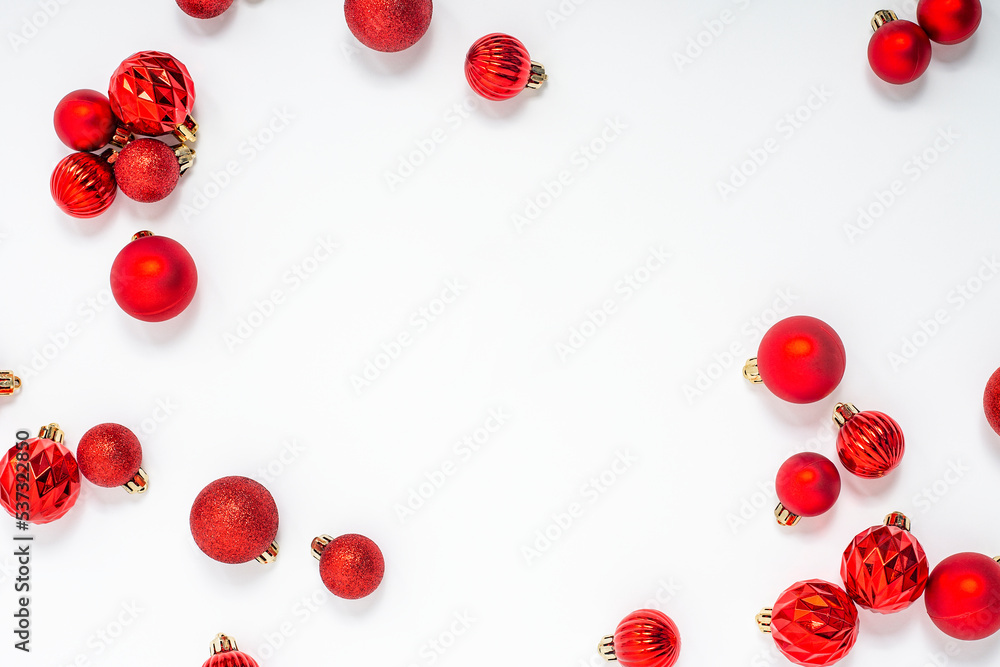 Decorative red balls on a white background. Top view, flat lay.