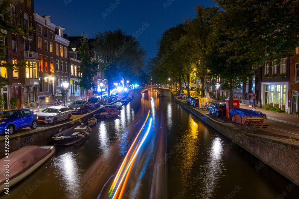 Night Canal in Amsterdam and Light Trails of Boats