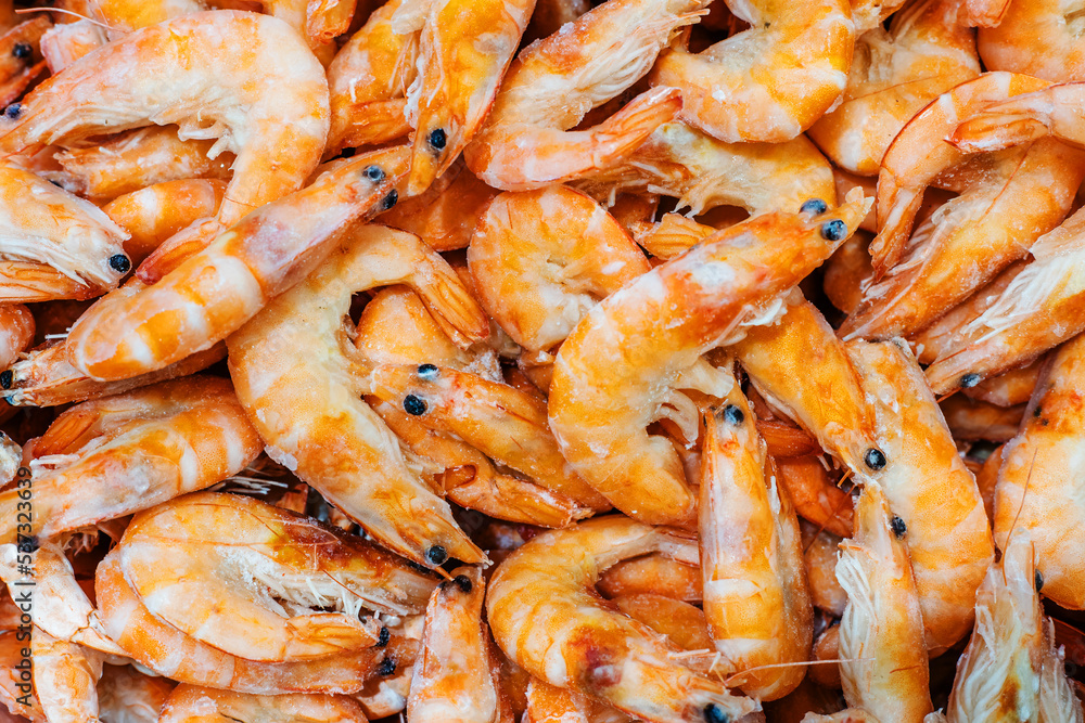 Orange shrimp on the counter in the store. Seafood trade in the wholesale and retail network. Close-up Orange shrimp on the counter in the store. Seafood trade in the wholesale and retail network. Close-up