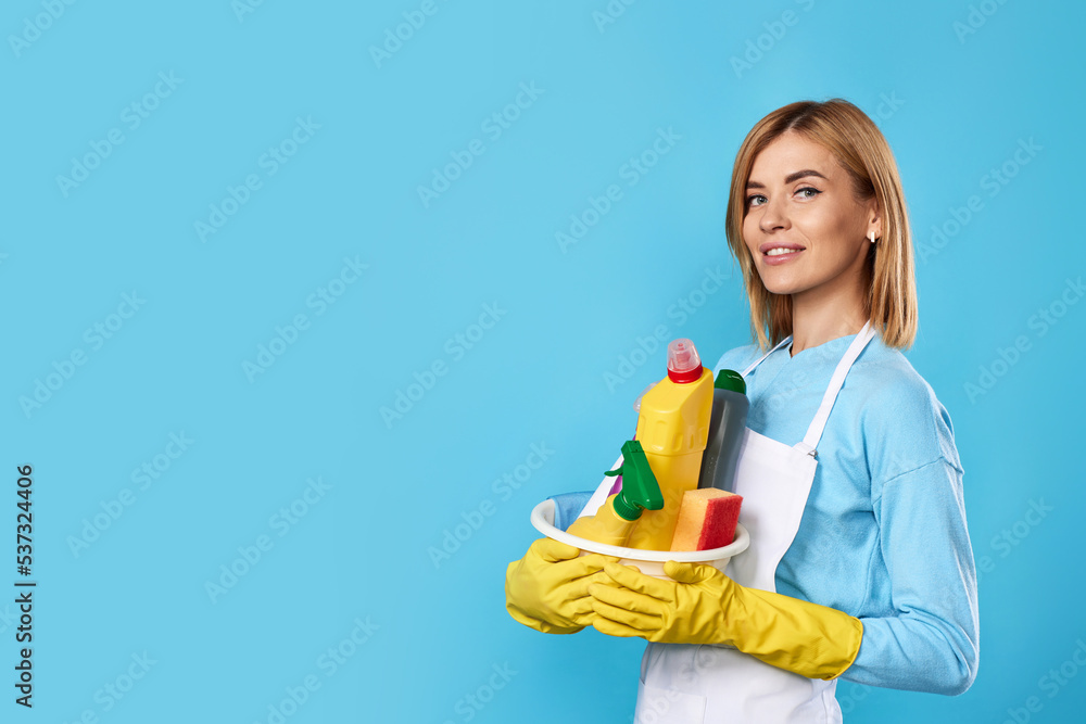 woman in gloves holding bucket with cleaning supplies woman in gloves holding bucket with cleaning supplies