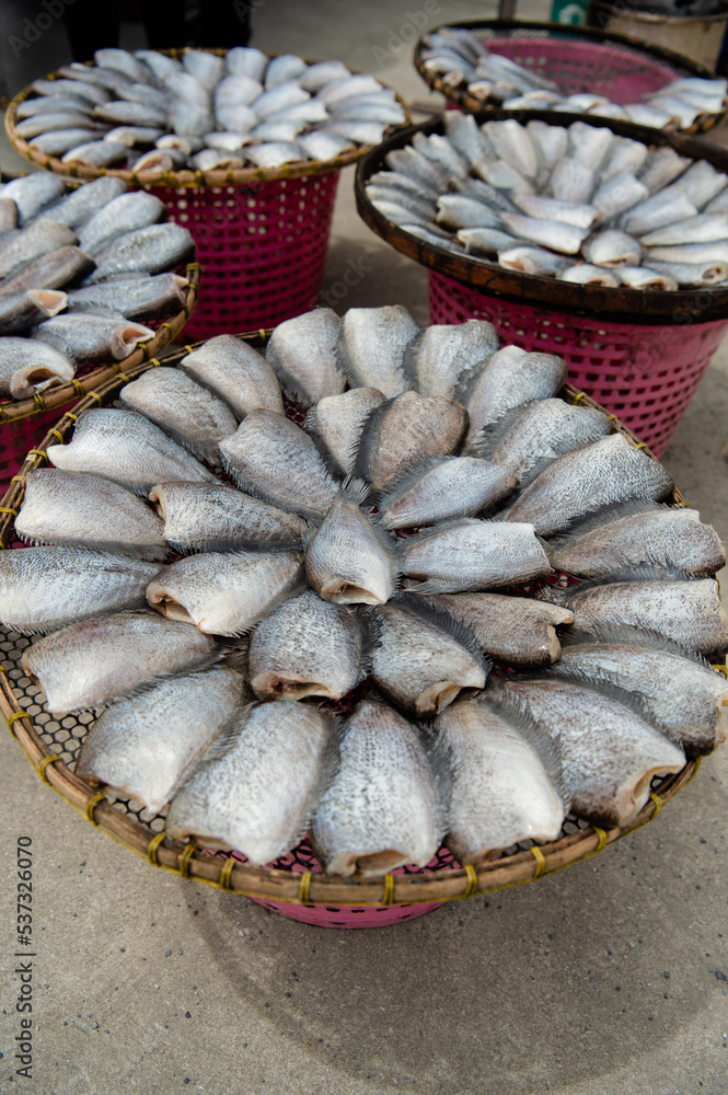 Dried Gourami in bamboo basket. Salted Gourami for food preservation, organic food, traditional Thai street food, close-up and top view - photo, Thai food