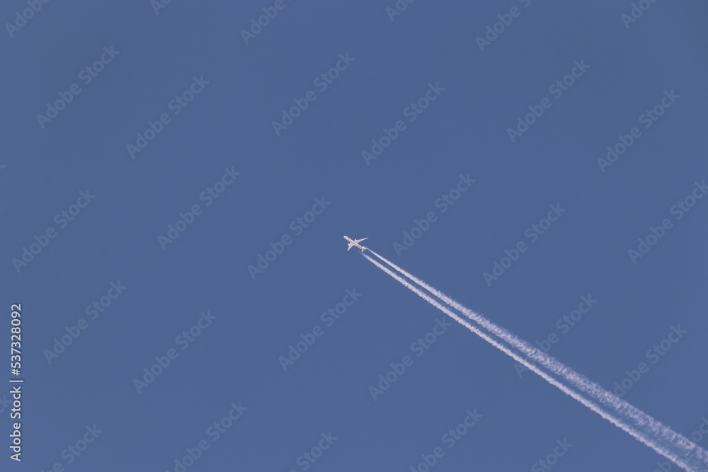 A jet in the sky with track behind