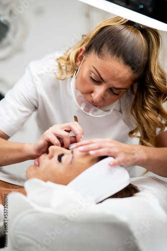 Woman Eye with Long Eyelashes. Beautiful Young Woman During Eyelash Extension.