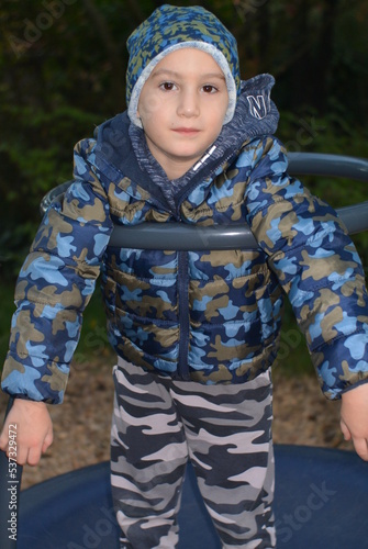 Boy in camouflage clothes on the playground 