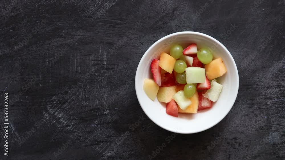 Eating a Bowl of Fresh Fruit Salad Eating a Bowl of Fresh Fruit Salad