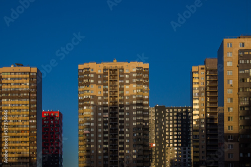Facades of modern multi-storey buildings against a bright blue sky and a space for copying in the city Reutov  Moscow region  Russia