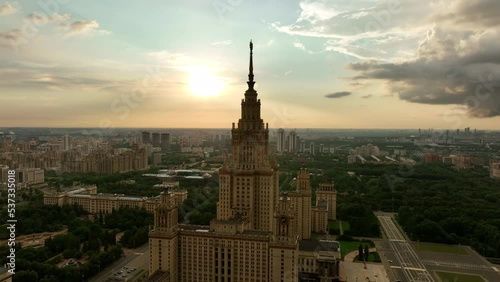The main building of Moscow State University at sunset of a cloudy stormy sky. The famous Stalin high-rise, a monument of Soviet architecture against the background of the modern city.