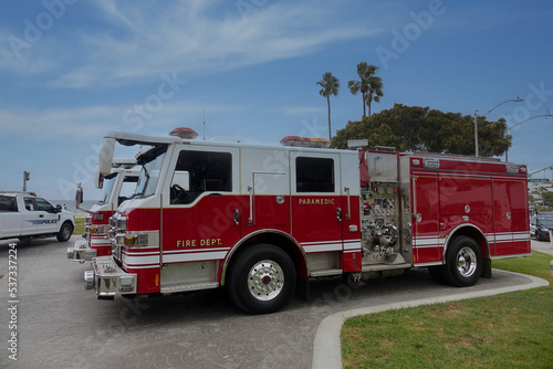 side view of red fire engine responding to emergency call