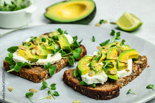 avocado toasts with cheese, pumpkin, nut and sesame. Healthy fats, clean eating for weight loss
