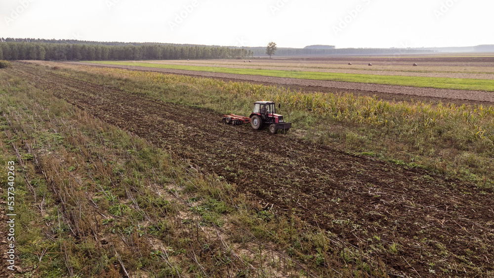 Tractor works the field. Photo from drone. Tractor works the field. Photo from drone.