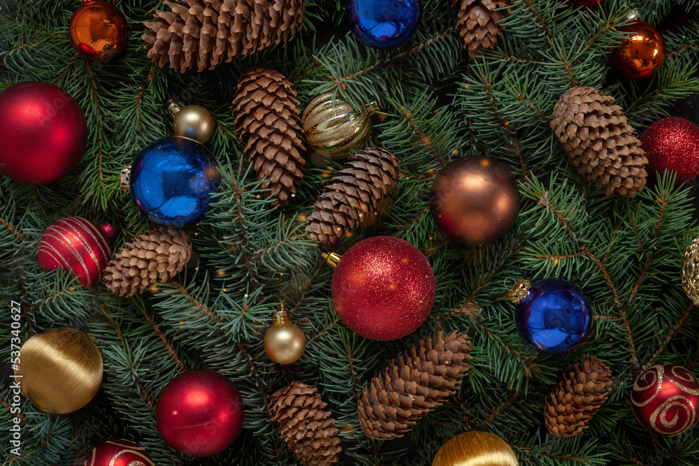 Christmas holiday background with Christmas decorations and fir tree branches with cones. Top view, close up