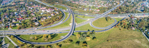 Highway multilevel crossing. Spaghetti junction on A4 international highway with Zakopianka road and railway, the part of freeway around Krakow, Poland. Aerial wide panorama from above