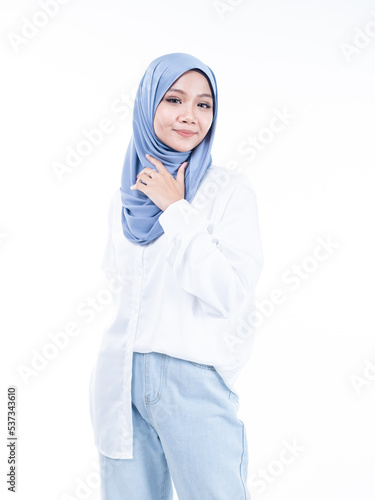 Half length portrait of a beautiful Muslim female model wearing modern and stylish casualwear with hijab isolated white studio background. Modern hijab fashion and beauty concept