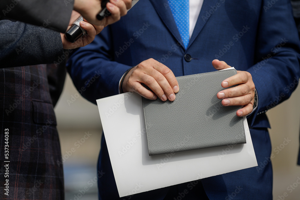 Fototapeta premium Shallow depth of field (selective focus) details with the hands of a politician making a press conference.