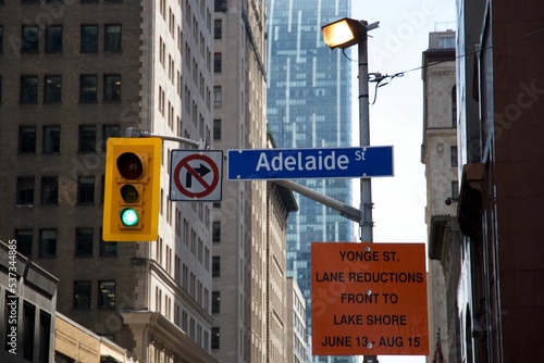 Photography Close-up shot of traffic lights and signboards on a street