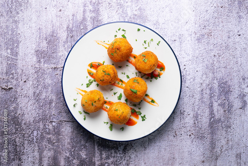 Tapa of Iberian ham croquettes. Recipe made with bechamel sauce and ham, all battered and fried in the shape of round balls.