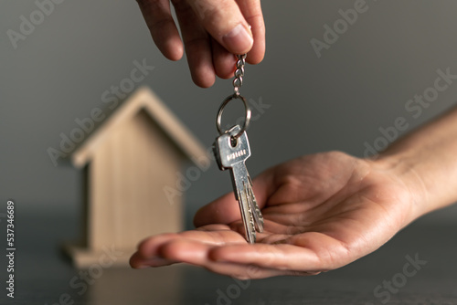 Woman's hand receiving the keys of her new house owned or rented.
