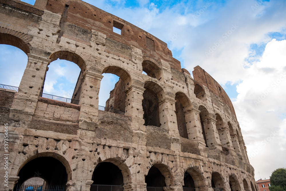 Colosseum against a blue sky with clouds. Italy, October 2022