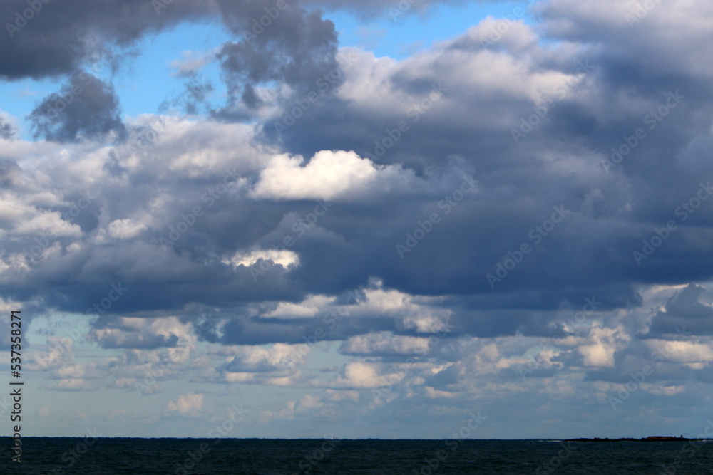 Large rain clouds in the sky over the sea. Large rain clouds in the sky over the sea.