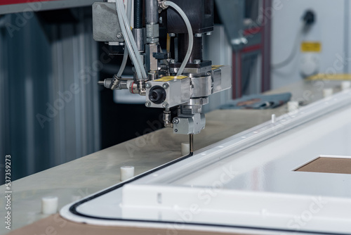Принти на полотні industrial robotic dosing dispenser machine applies a hardening sealant to the m