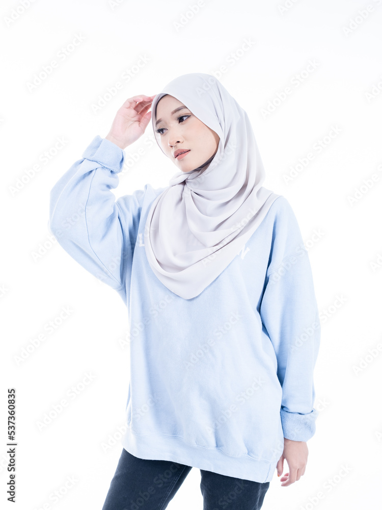 Portrait of a beautiful Muslim female model wearing modern and stylish casualwear with hijab isolated white studio background. Modern hijab fashion and beauty concept Portrait of a beautiful Muslim female model wearing modern and stylish casualwear with hijab isolated white studio background. Modern hijab fashion and beauty concept